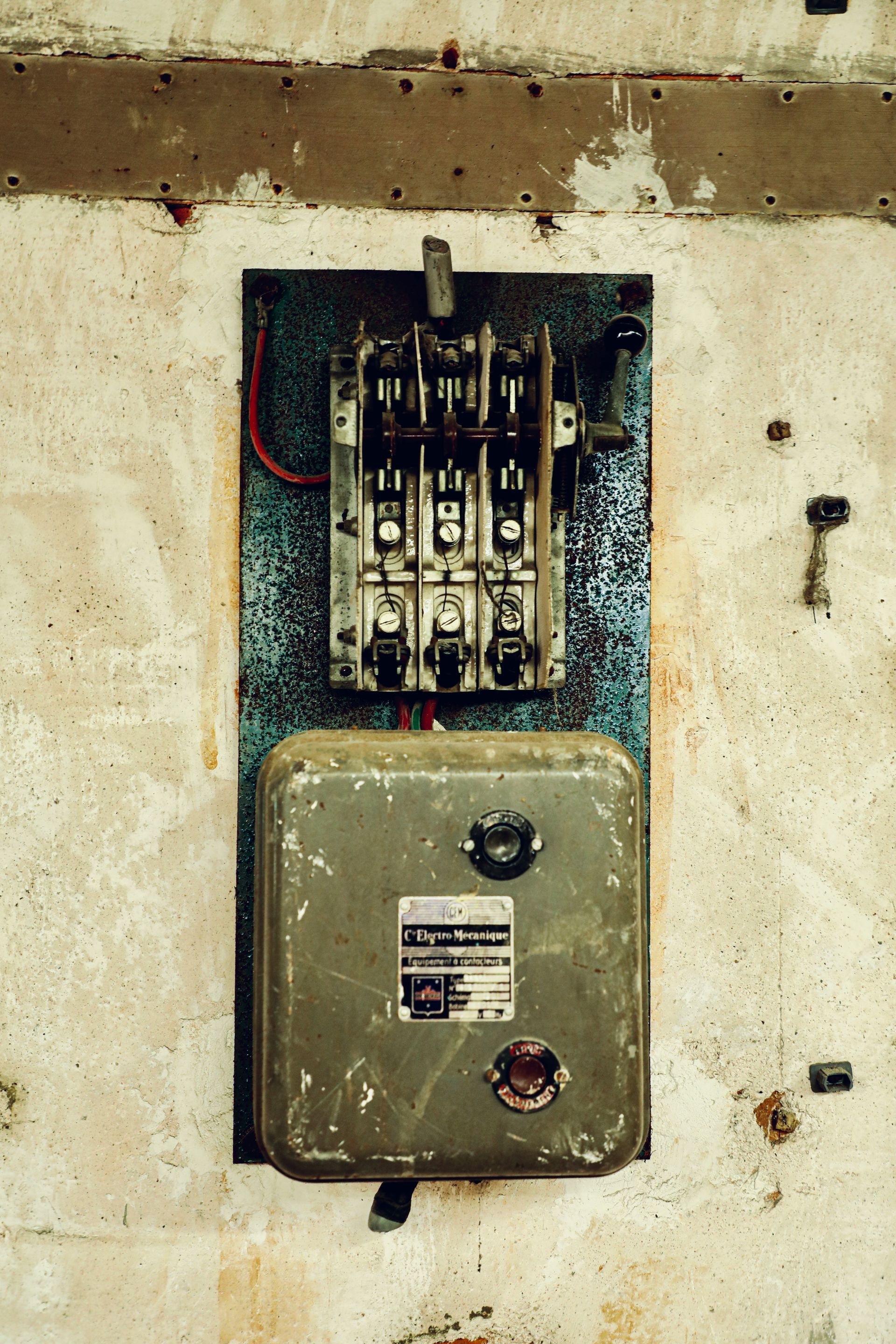 Old electrical breaker box mounted on a wall